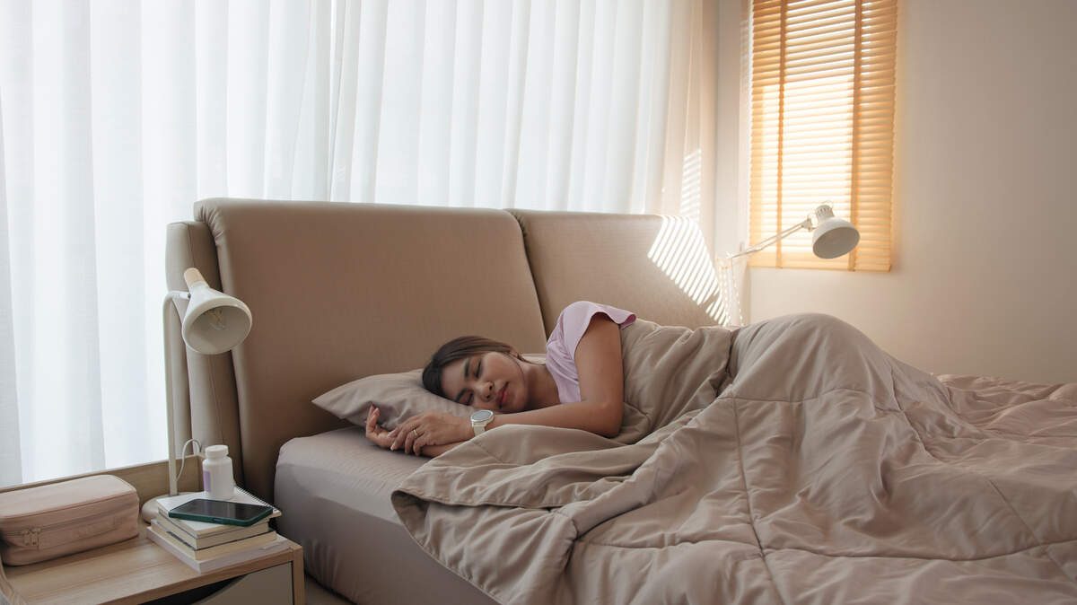 Magnesium Glycinate for Sleep: How Much to Take, When & Does It Really Work? young adult woman black asia people take herbal cbd pill bottle lying down on soft cozy bed deep sleep aid calm. waking up happy serene relax drug anti aging good health care fall asleep well morning.